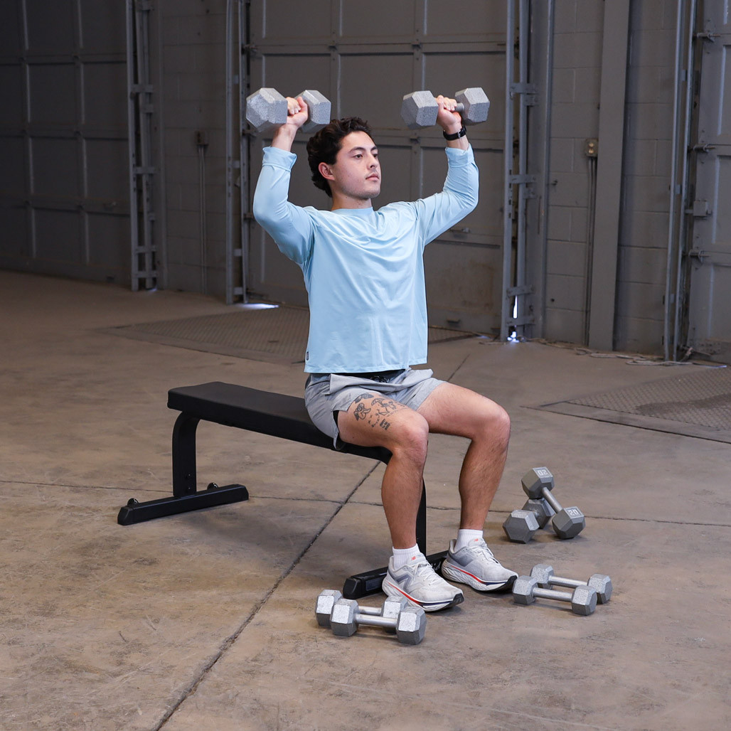 Athlete performing a dumbbell exercise on the Body-Solid GFB350B flat bench