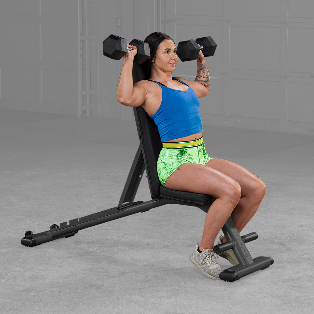 Athlete training on the Body-Solid GFID225B folding bench