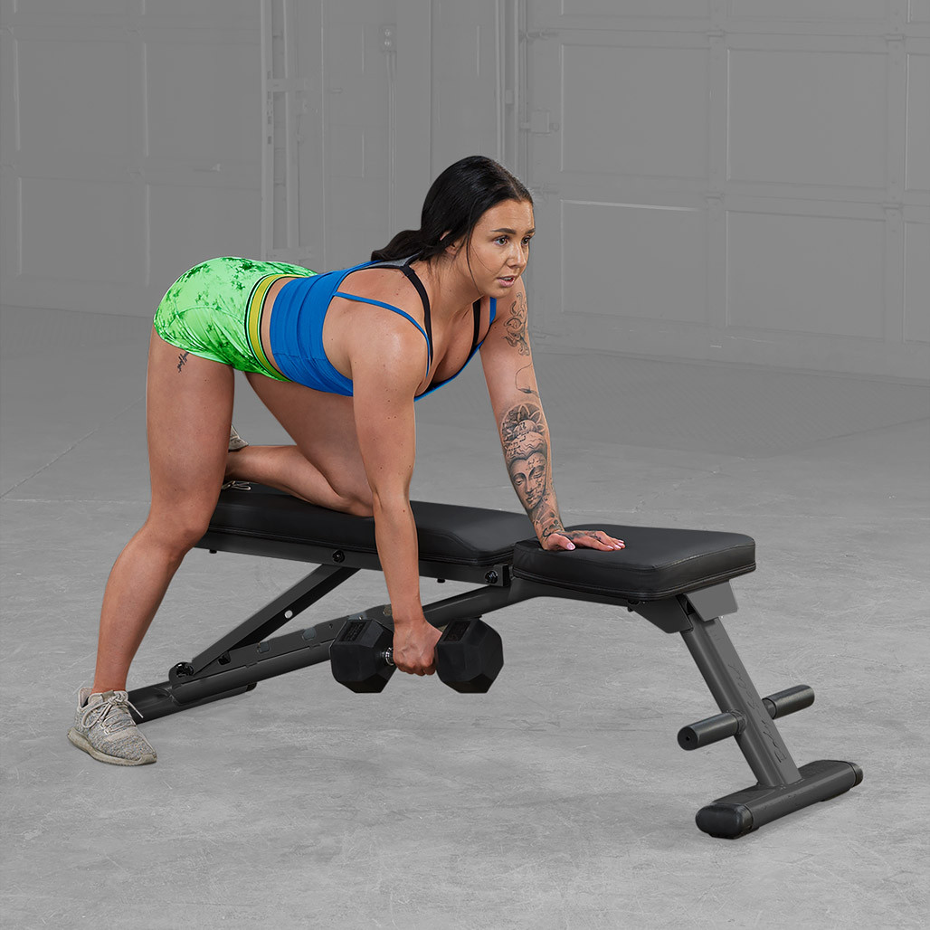 Athlete using the Body-Solid GFID225B folding bench for a press