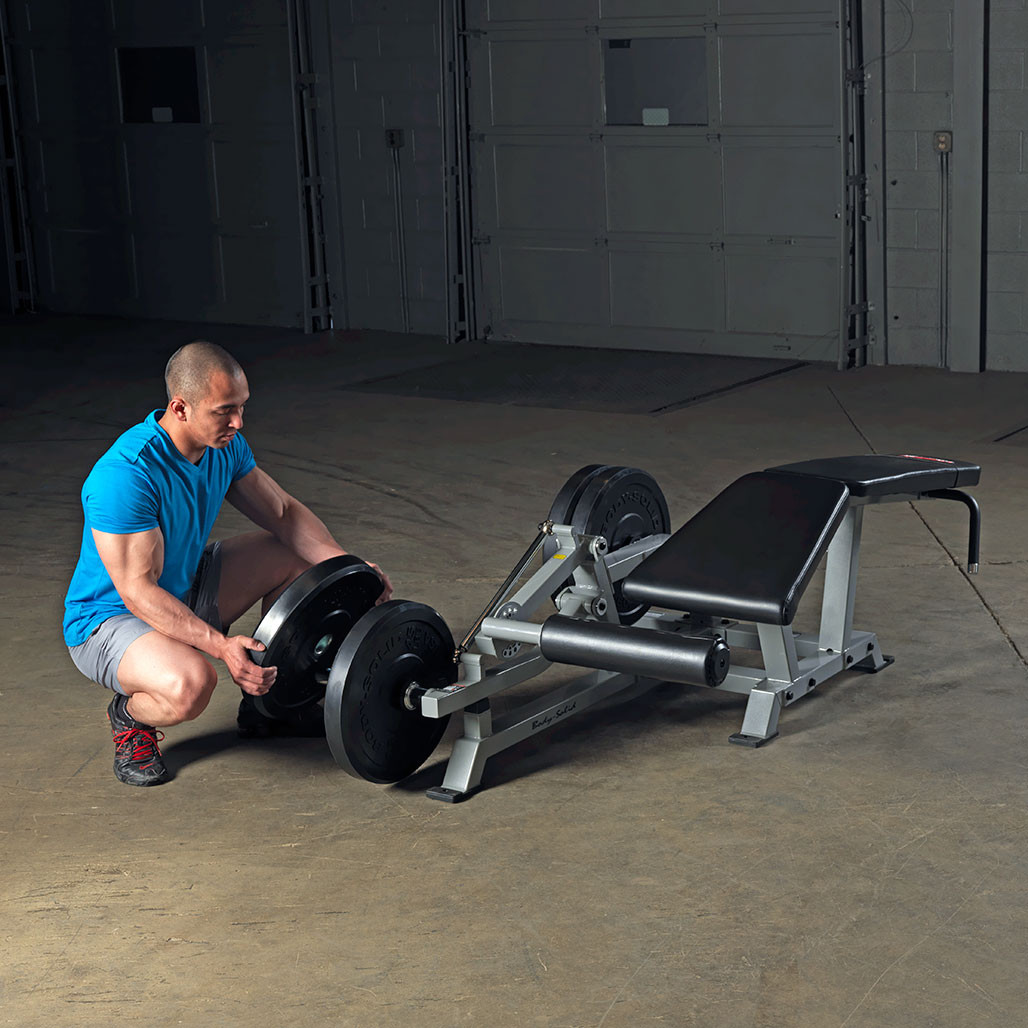 Athlete training hamstrings on the Body-Solid LVLC Leverage Leg Curl