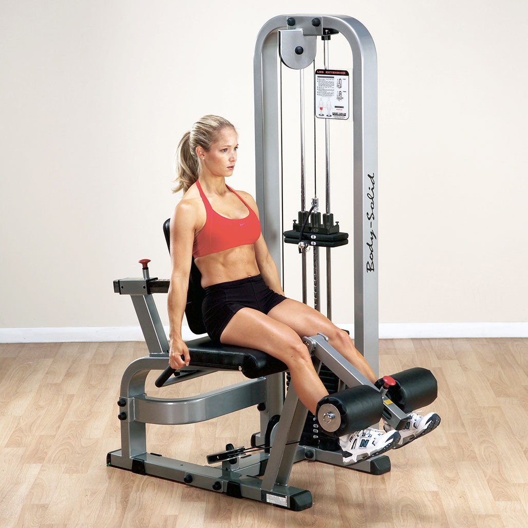 User performing a seated leg extension on the Body-Solid SLE200G