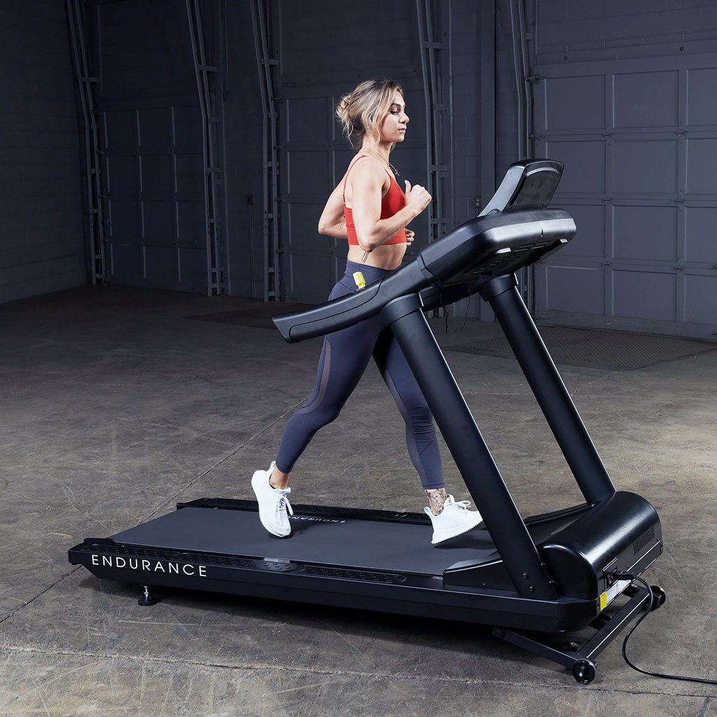 Athlete running on the Endurance T150 commercial treadmill with 0-15 percent incline