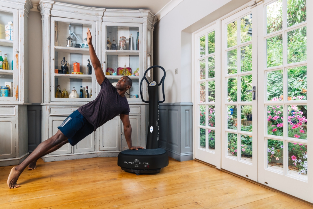 Man performing a side plank on a Power Plate my5 whole body vibration platform