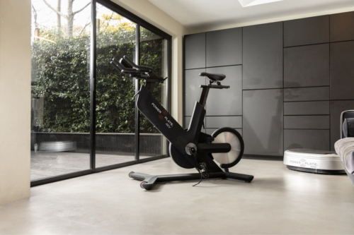 Power Plate REV matte black indoor cycle, angled rear view