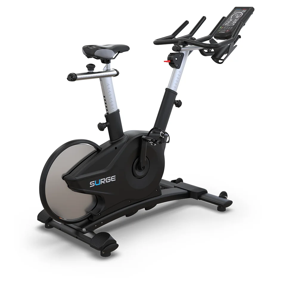 TRUE Surge indoor cycle rear three-quarter view with rear flywheel and adjustable seat