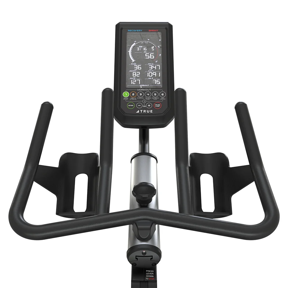 TRUE Surge indoor cycle from the rider's seat showing the console and handlebars