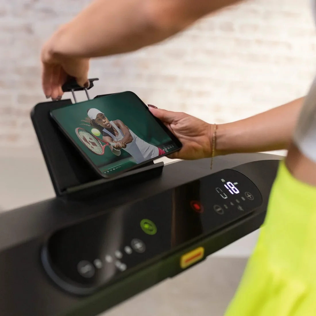 Hand placing a tablet in the Centr Runr console holder
