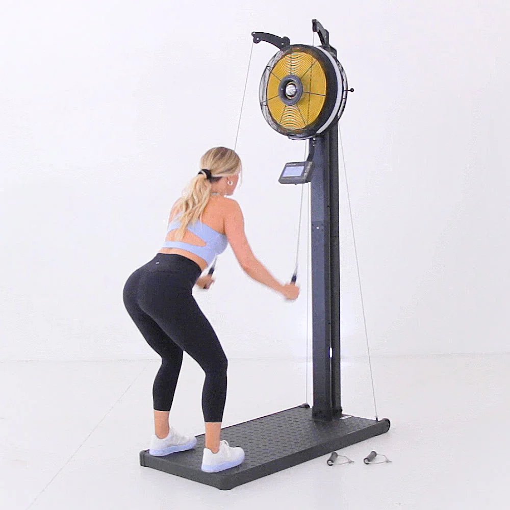Athlete performing a double-arm ski pull on the Renegade Raptor Functional Trainer with the fan in the high position