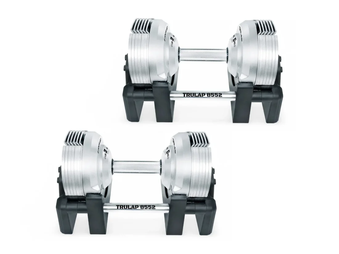 Side profile of the two Trulap 8552 G4 dumbbells in their bases, showing the handle and plate stack