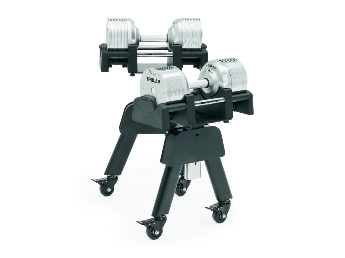 Trulap 8592 G4 dumbbells docked on the G3 rack, side angle showing the casters and splayed legs